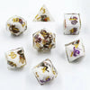 A set of milk white resin dice featuring a black kitten design, displayed at various angles.