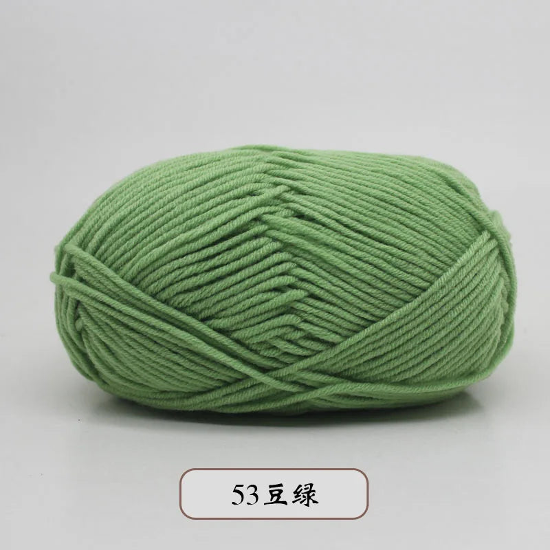 A ball of soft, light green pre-dyed milk cotton yarn for knitting and crochet.