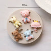 A set of silicone baby-themed cake molds including teddy bears, a pink bear, and a pink umbrella.