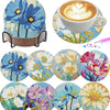 A set of floral diamond painting coasters featuring blue, yellow, and pink flowers with a metal holder.