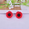 Pair of red felt flower charms with black centers for jewelry making