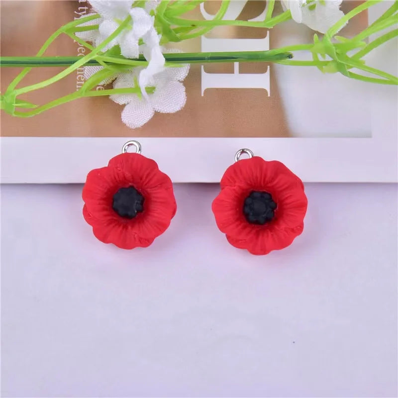 Pair of red felt flower charms with black centers for jewelry making