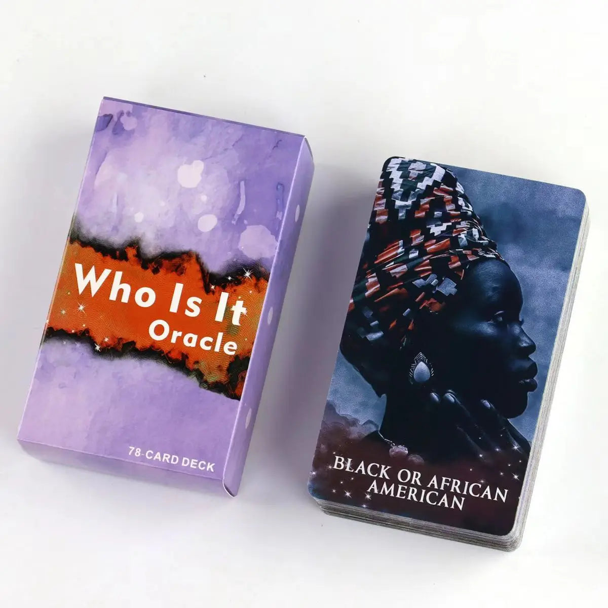A purple box of the Twin Flame Love Oracle Deck with an orange silhouette design and a card featuring a black silhouette prof