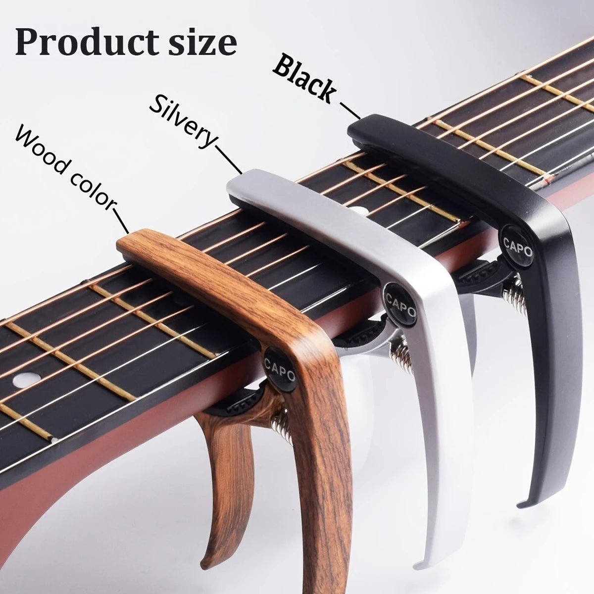A close-up view of an aluminum alloy quick-change guitar capo in black, silvery, and wood colors.