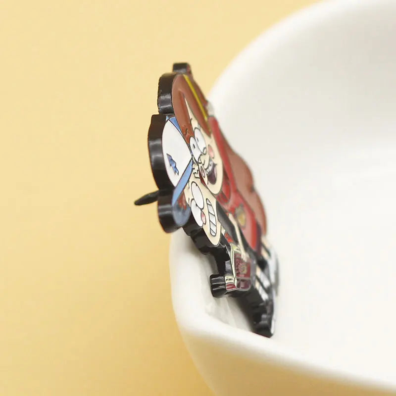 A set of Gravity Falls enamel pins featuring a boy and girl for backpacks and jackets displayed on a white surface.