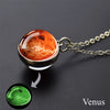 A pendant necklace featuring a glass orb with an orange-red glow, representing Venus.