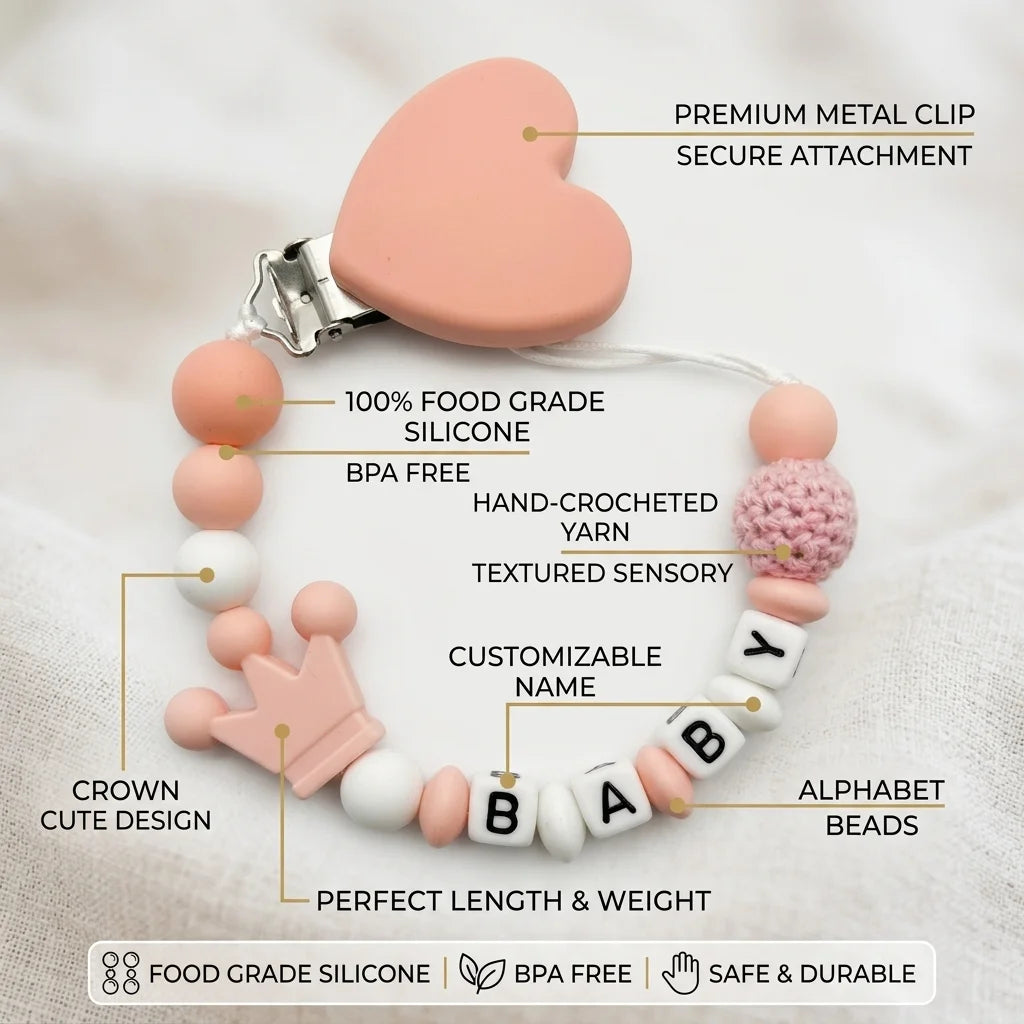 A pink silicone pacifier clip featuring a heart charm and alphabet beads for a baby
