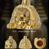 A handcrafted gold Aztec death whistle shown from the front, back, and side views.
