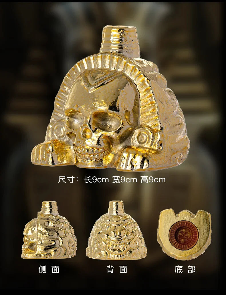 A handcrafted gold Aztec death whistle shown from the front, back, and side views.