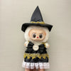 A Halloween pumpkin costume set featuring a black witch hat, white fluffy face, and black dress with gold trim for 17cm dolls