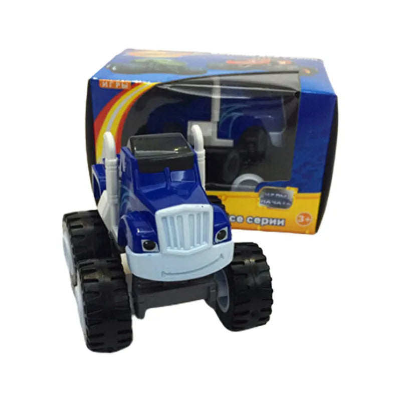 A blue and white die-cast monster truck toy vehicle with large tires and a box in the background.