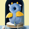 A soft blue security pillow backpack for newborns with yellow accents displayed on a stand.