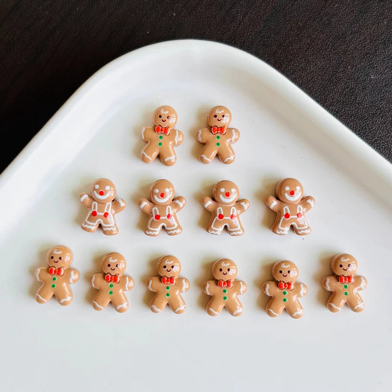 A white oval dish holds thirty small gingerbread man resin charms with red and green accents.