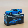 A blue Nissan Skyline GT-R model car in a box, featuring a rear spoiler and wheels.