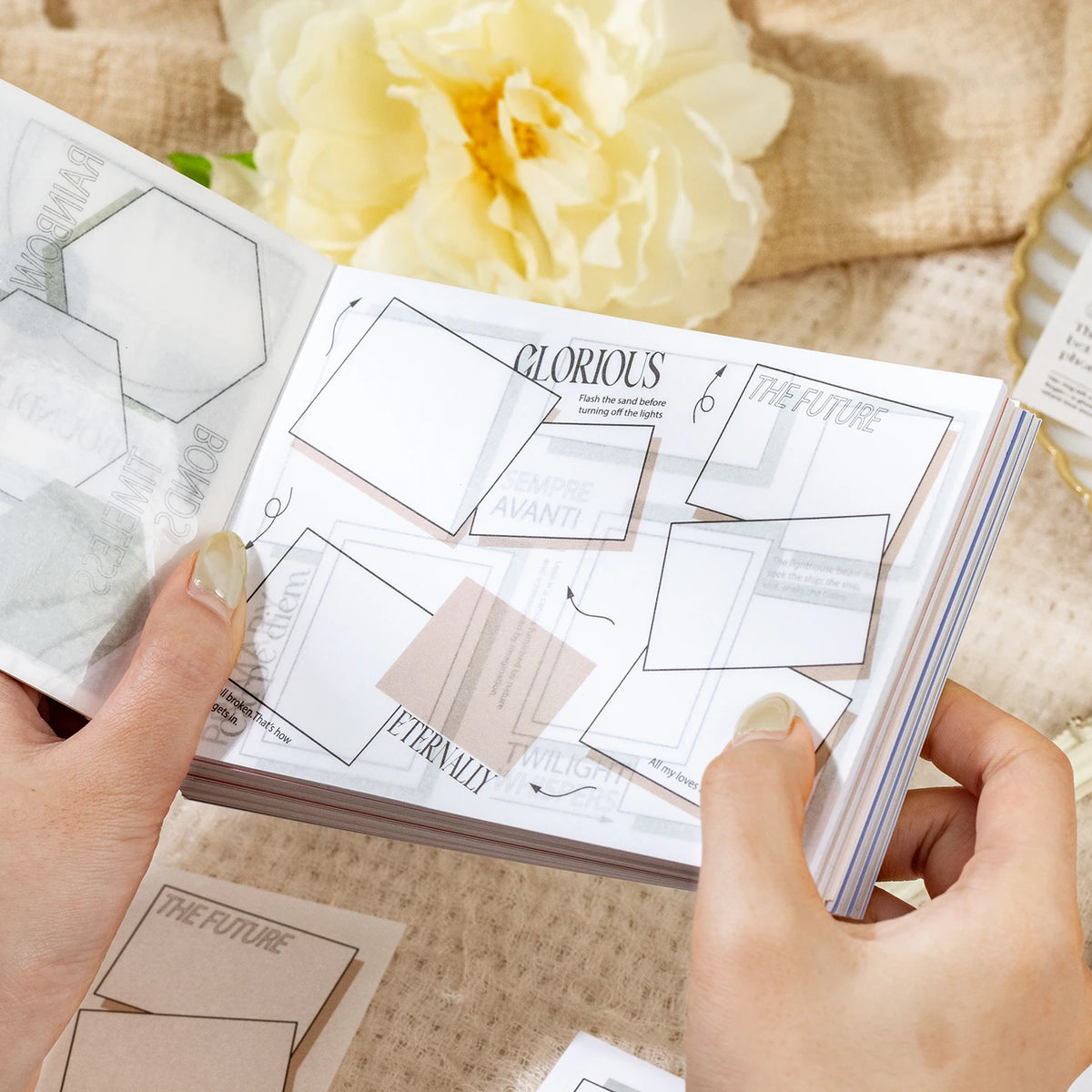 Hands display a set of dual-material frame stickers for journaling and scrapbooking on a light beige background.