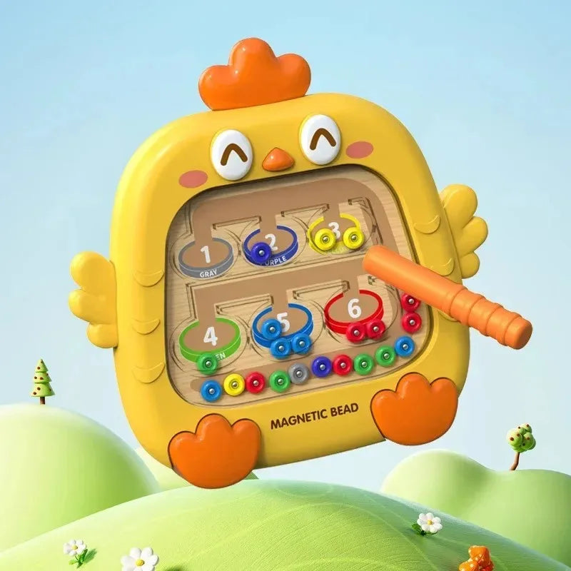 A yellow, egg-shaped magnetic bead puzzle board with orange features is shown against a green, outdoor background.