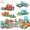 A set of magnetic building tiles featuring a road and rail layout with an electric car.