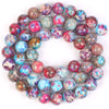A circular arrangement of natural sea sediment jasper and turquoise beads for jewelry making