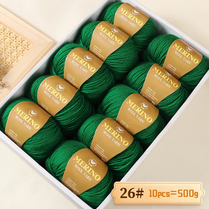 A box of green Merino wool yarn balls labeled 26, containing 10 pieces totaling 500g.
