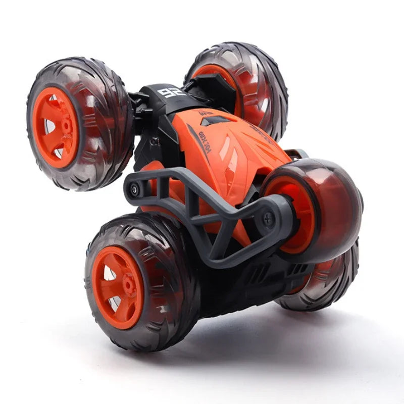 Black and orange stunt car with five transparent wheels ready for action.