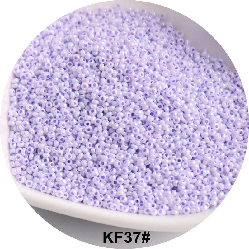 A pile of small, round, purple glass seed beads for jewelry and craft.