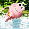 A pink frog bath toy with a yellow accent, floating in water.