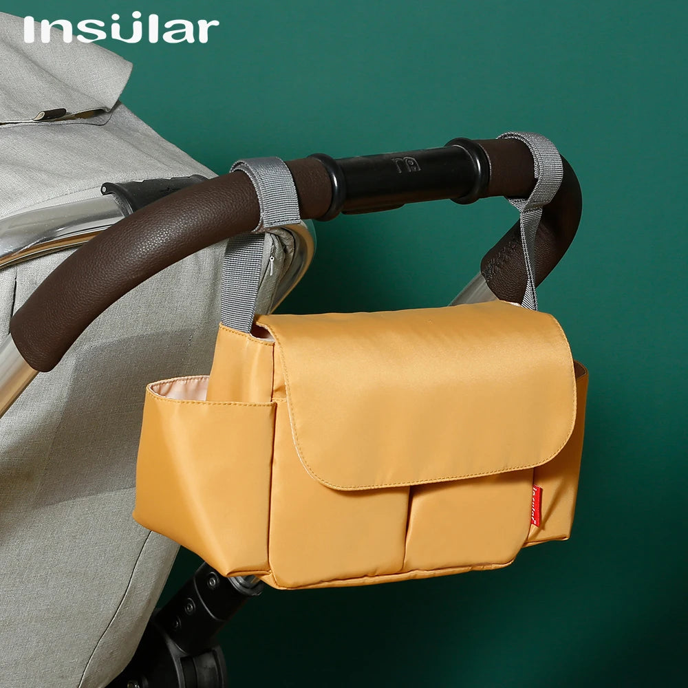 A yellow leather bottle holder is attached to a stroller handlebar.