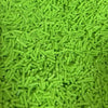 A pile of bright lime green soft polymer clay candy sprinkles for cake decorating.
