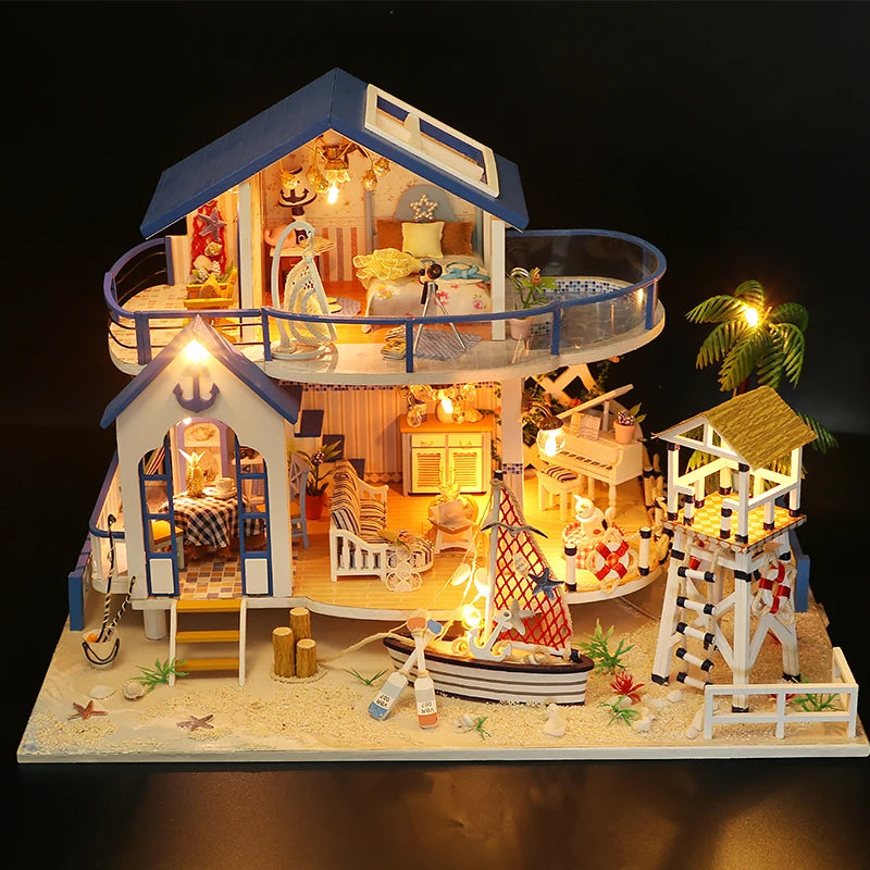 A detailed miniature dollhouse kit of a seaside beach house with an upper floor, featuring wooden structures and LED lights.