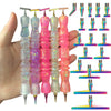 A hand holds a set of diamond painting pens with interchangeable resin tips in various colors and sizes.