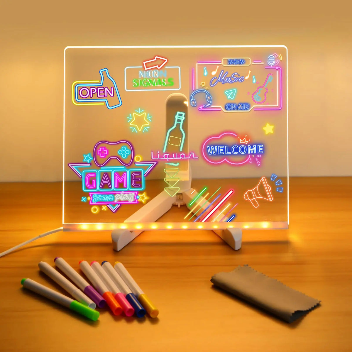An LED acrylic message board displays neon signals and a welcome message with 7 colored pens in front of it.