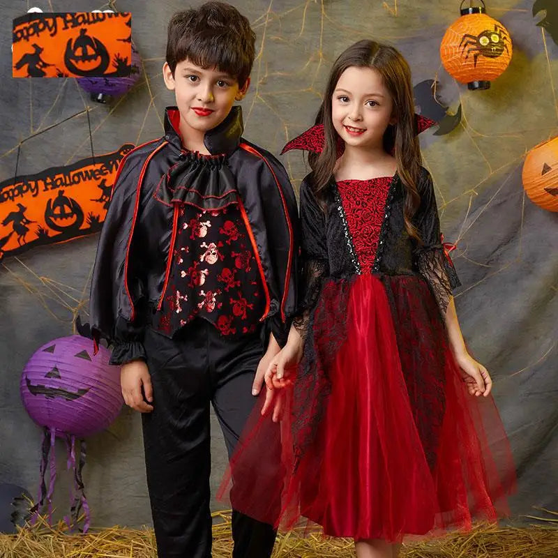 Two children dressed in vampire bat costumes with capes and accessories posing against a textured background.