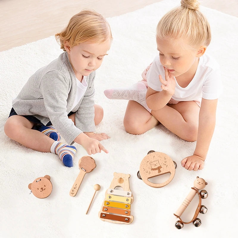 A set of wooden bear musical instruments including a wooden bear, a wooden flute, and various wooden percussion instruments f