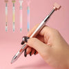 A hand holds a silver pen with a rotating wax tip and various colored gradient refills for nail art.