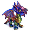 A detailed, articulated 3D printed dragon figurine with iridescent purple and green scales.