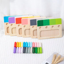 A set of wooden color matching blocks in various colors arranged in a row on a white surface.