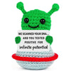 Handmade crochet positive alien pocket hug gift with green textured body and light blue accents