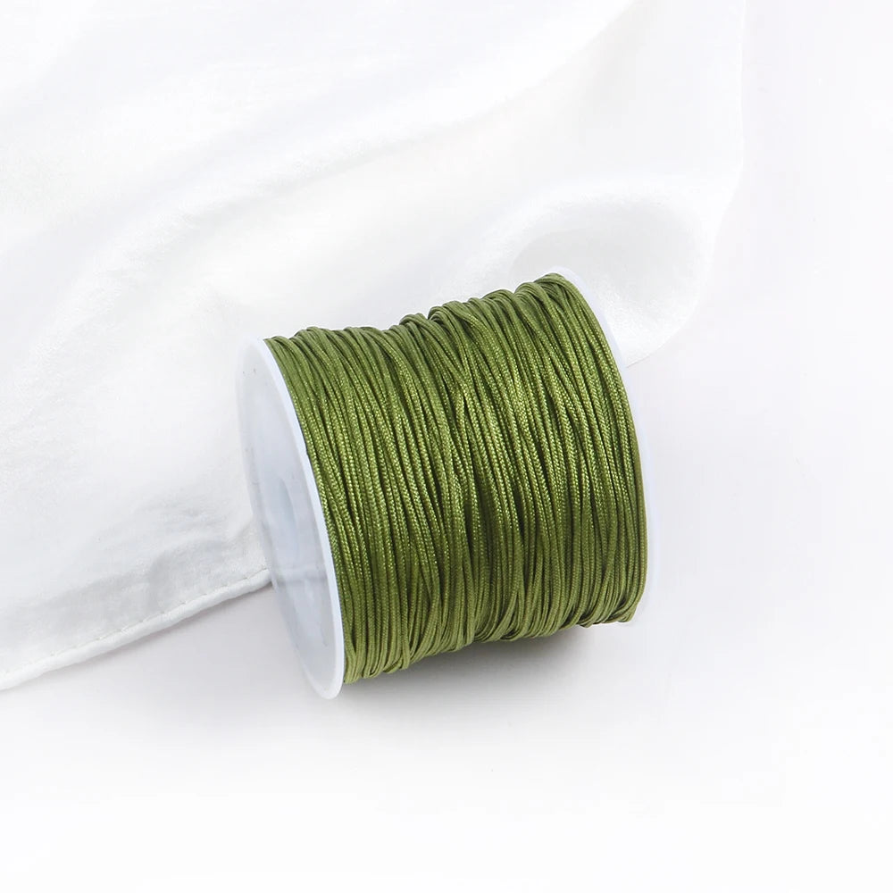 A roll of olive green cotton nylon macrame cord for jewelry making and crafts.