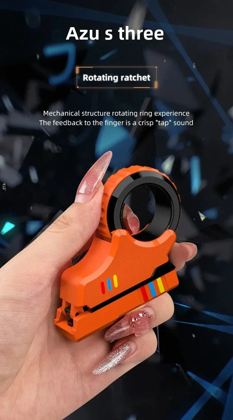 An orange magnetic fidget card with a rotating ratchet mechanism is held in a hand against a dark, technical background.