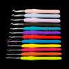 A collection of various crochet hooks and knitting needles in different colors and sizes laid out on a black background.