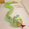 A bright green cartoon snake plush toy with large eyes is coiled on a white surface.