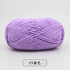 Purple pre-dyed milk cotton yarn in a skein, showing the twisted texture.