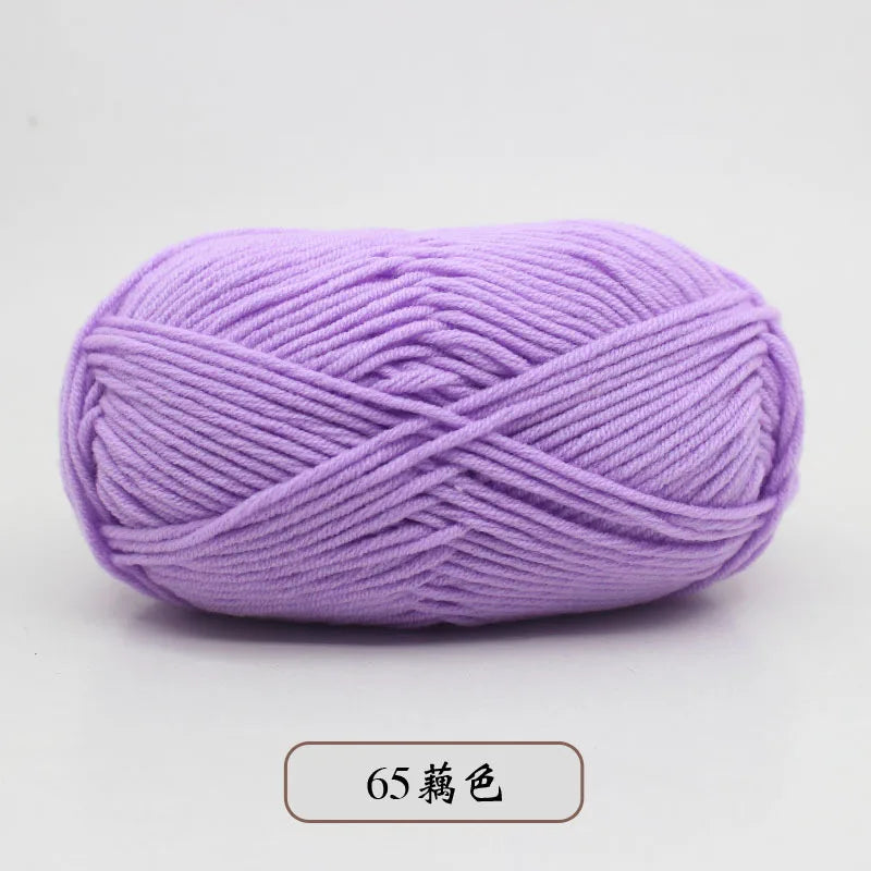 Purple pre-dyed milk cotton yarn in a skein, showing the twisted texture.