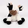 A white and black plush cow toy with brown accents, featuring soft, fluffy texture.