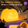 A glowing orange pumpkin LED night light is shown with a hand, set against a dark outdoor background.