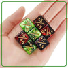 A hand holds a set of ten dual-color dice featuring both positive and negative numbers.
