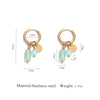 Gold-toned hoop earrings featuring a light green gemstone and a gold disc accent.
