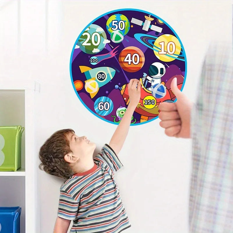 A young boy is reaching for a large circular dart board decorated with colored sticky balls and numbers.