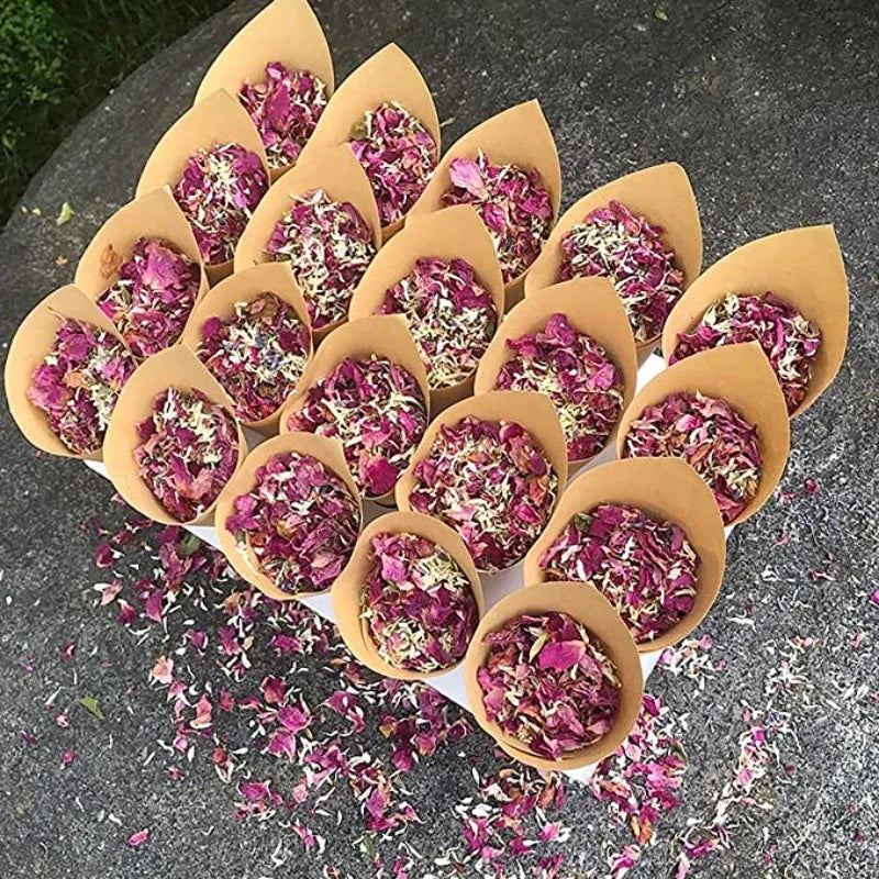 Dried rose petal confetti in natural pink and purple hues arranged in paper cups.