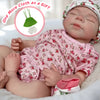A lifelike 18-inch silicone reborn baby doll named Pascale lying in a white blanket.